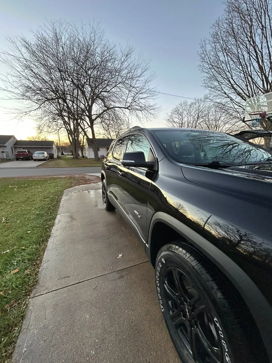Black GMC Acadia side after an exterior detail