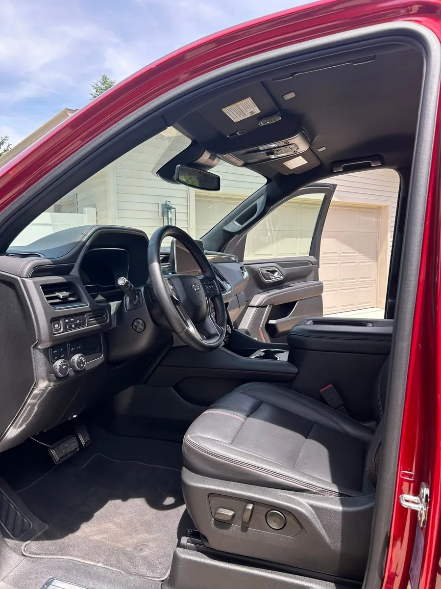 Red Chevy Tahoe driver side after an interior detail
