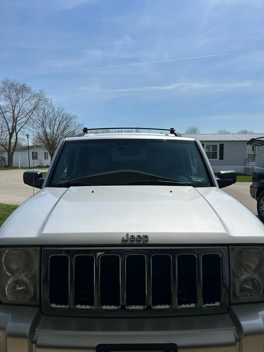 Silver Jeep Commander front after a wash
