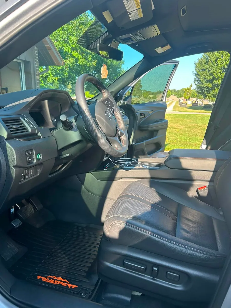 SUV black leather front seats after detailing